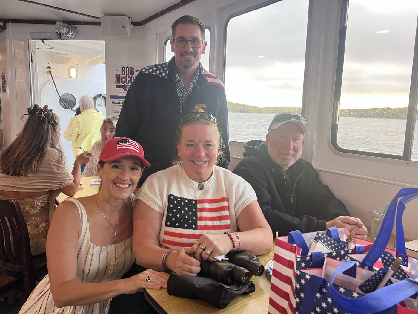 Guests at a table with flags aboard the canal cruise
